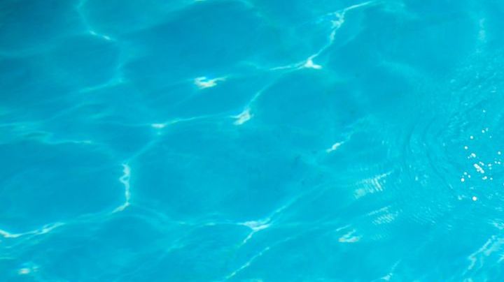 woman tanning at pool