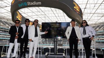 Members of the Mexican grupera band Los Bukis, from left, Pedro Sanchez, Roberto Guadarrama, Marco Antonio Solis, on screen Joel Solis and Pepe Guadarrama, and Eusebio "El Chivo" Cortez and Jose Javier Solis attend a press conference at SoFi Stadium on Monday, June 14, 2021, in Inglewood, Calif. Twenty five years after their last show as a band, the group announced that they are reuniting for a U.S. tour. (AP Photo/Chris Pizzello)
